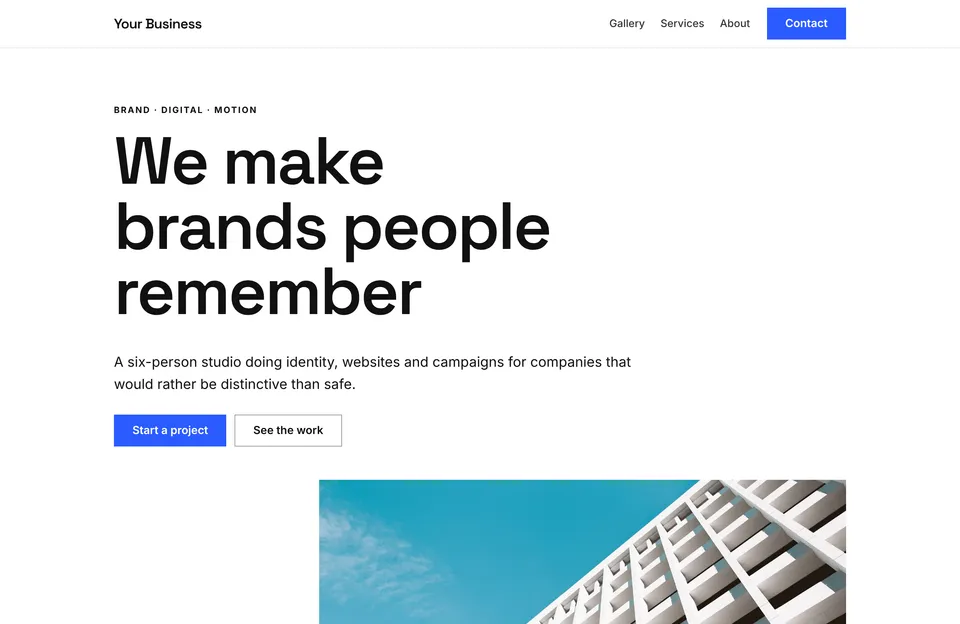 Studio template: a bold sans-serif headline, two buttons and a photo of a modern building facade